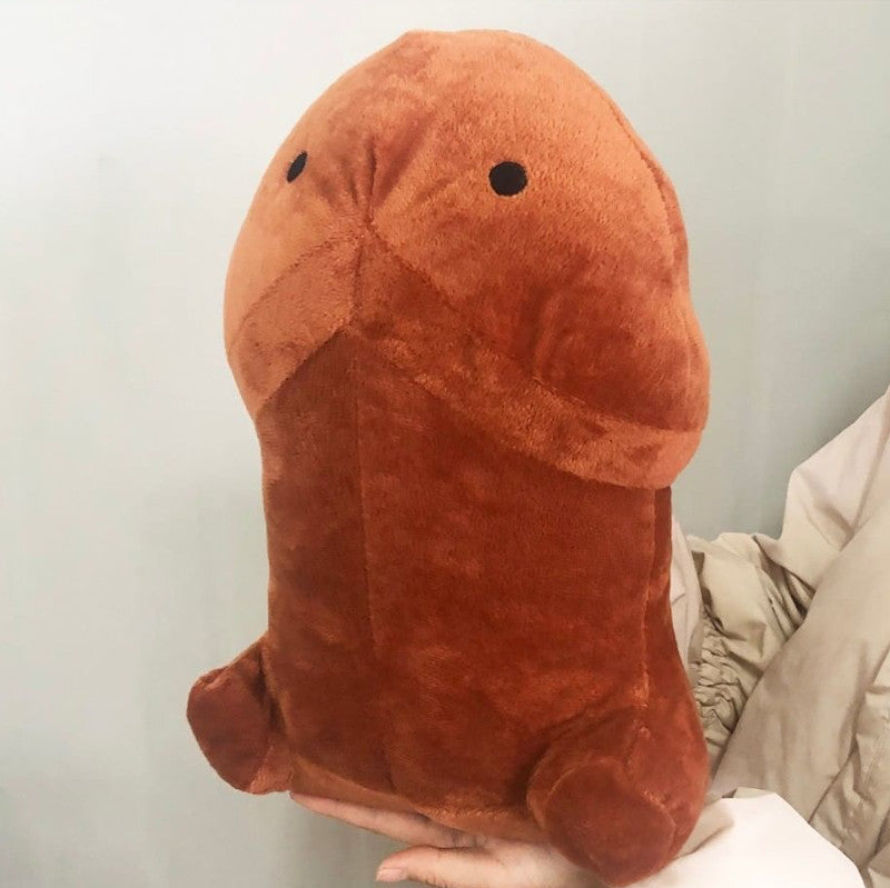 brown furry dick pillow being held in the hand with grey background