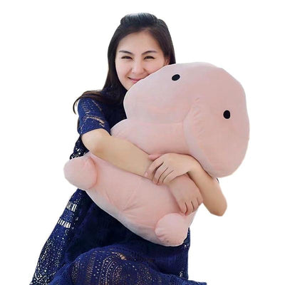 woman hugging the pillow that is shaped like a dick
